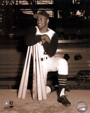 Roberto Clemente leaning on bats