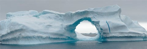 Blue iceberg with hole, Antarctica