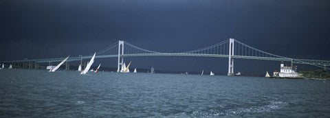 Storm approaches sailboats racing past Rose Island lighthouse and Newport Bridge in Narragansett Bay, Newport, Rhode Island USA