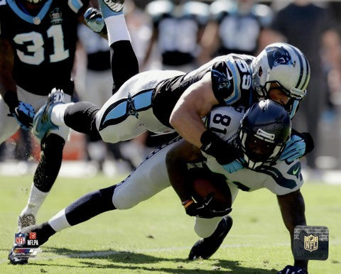 Luke Kuechly with the ball 2014