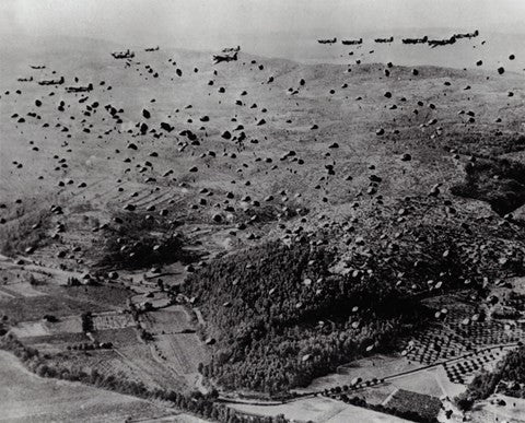 Parachutes fly after Air Force Troop Carrier drops Allied soldiers and supplies during the Allied Invasion of France