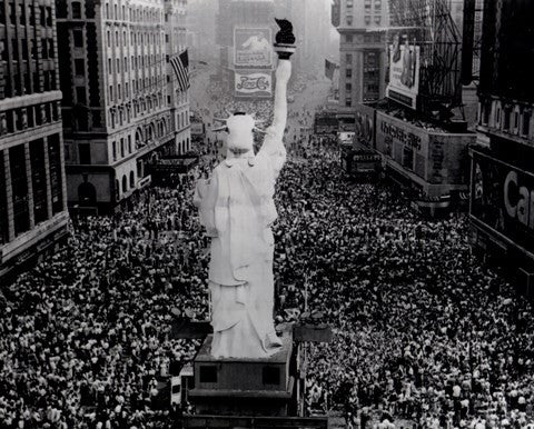 Crowds cheering as President Truman announces Japan's surrender at the end of World War Two